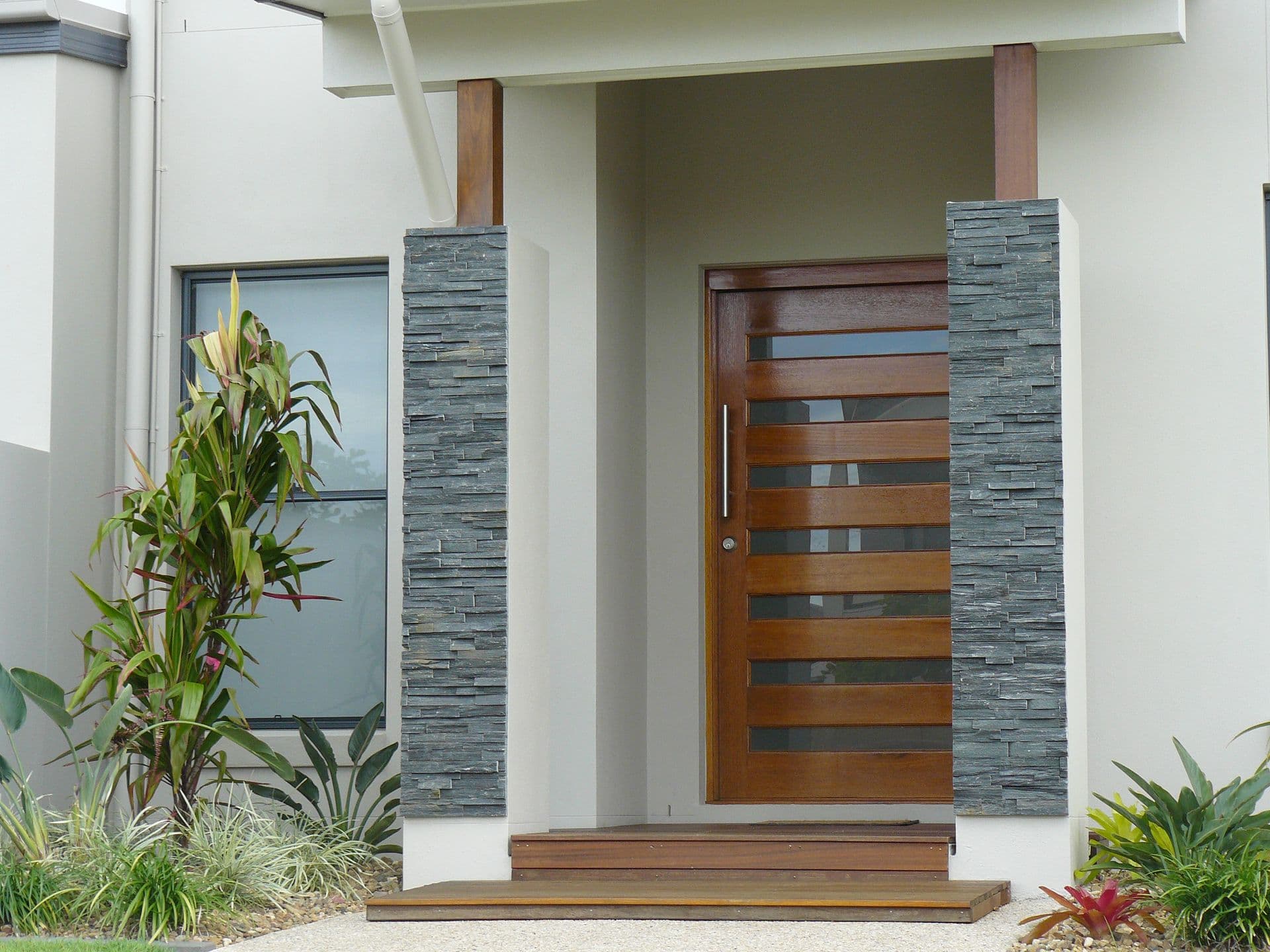 Appealing entrance to this modern home with render feature slate tiling and solid wood door.
