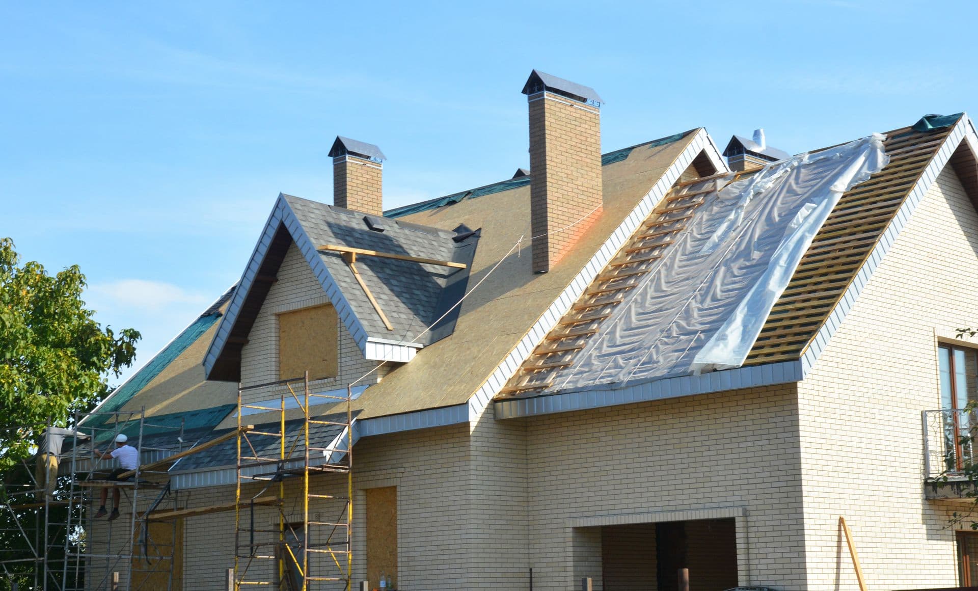 Roofing Contractors Installing House Roof Asphalt Shingles. Roofing Contractor Repair Roofing Construction. Roof Renovation with Asphalt Shingles